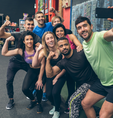 group in gym posing for photo